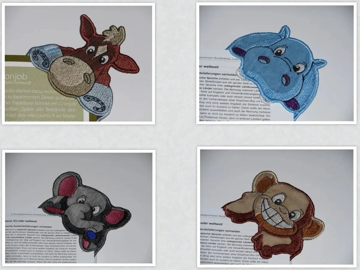 Gestickte Lesezeichen mit Tiermotiven: Stier, Nilpferd, grauer Elefant und beiger Affe auf Papierhintergrund.